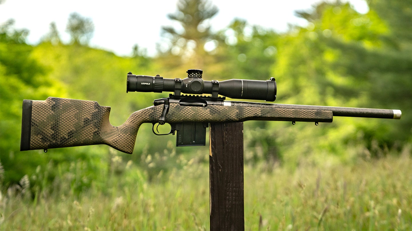 The new Proof Research Elevation 2.0 rifle balanced on a post in a field.
