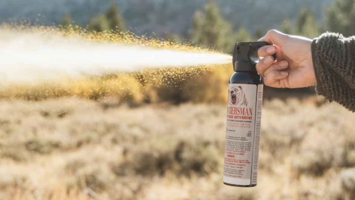 Woman spraying Sabre Frontiersman Bear Spray in the field
