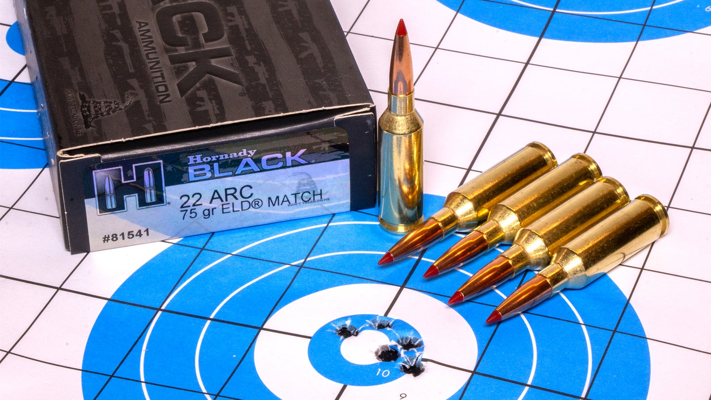 Hornady's new 22 ARC ammo sitting on a rifle target with five bullet holes in the center.