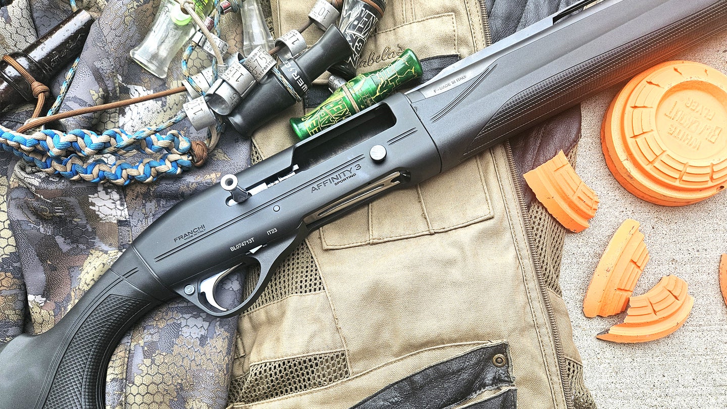 The new Franchi Affinity 3 Sport Trap shotgun resting on a shooting vest with clay targets and duck calls nearby.