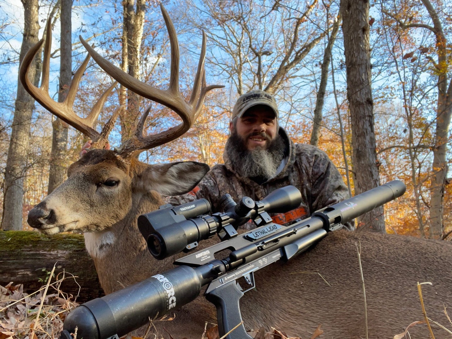 Chad Simon holds up a whitetail buck taken with a pre-charged pneumatic air rifle.
