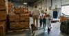 Gunner Kennels founder Addison Edmonds and family walking through warehouse