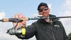 Bass Pro Jeff Gustafson holds out a spinning rod rigged with a jighead minnow bait. 