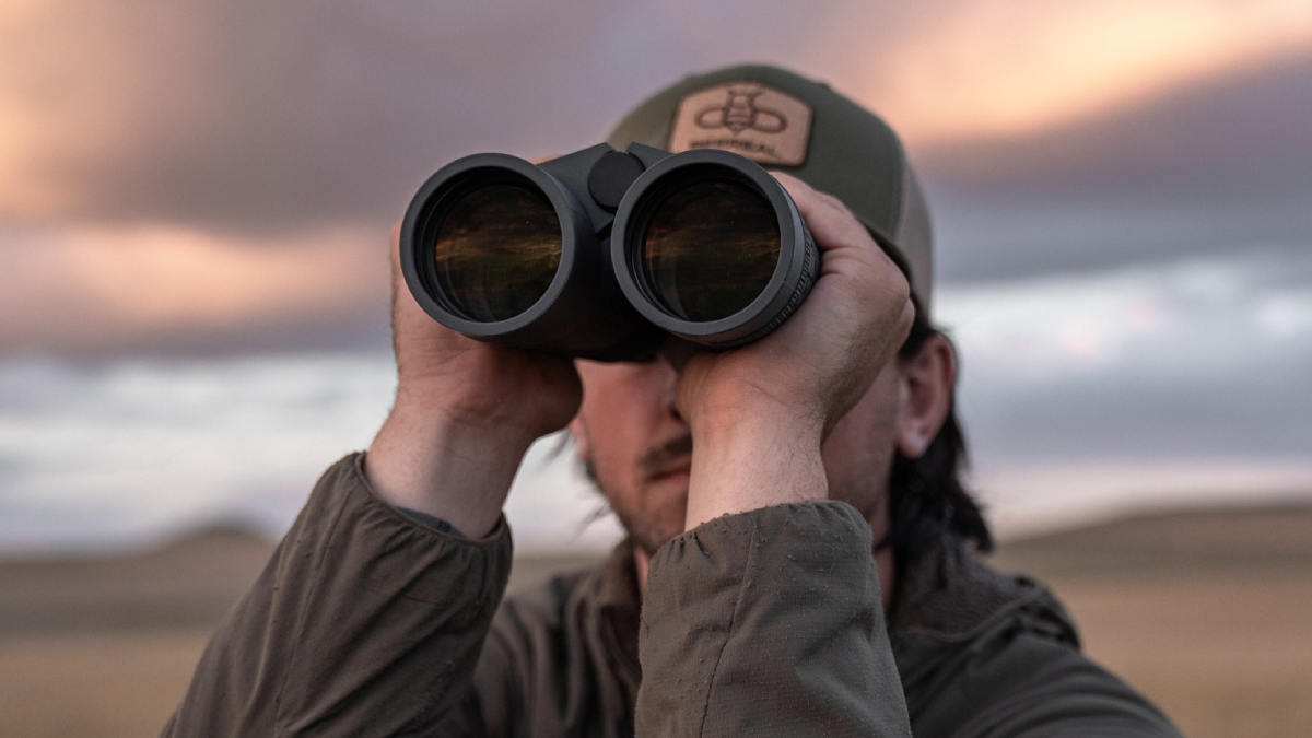 Man looking through Leupold binoculars