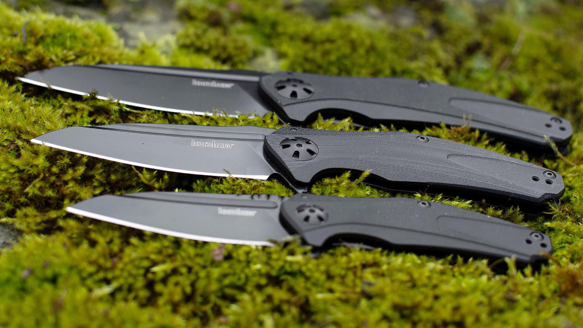 Kershaw folding knives laying on grass