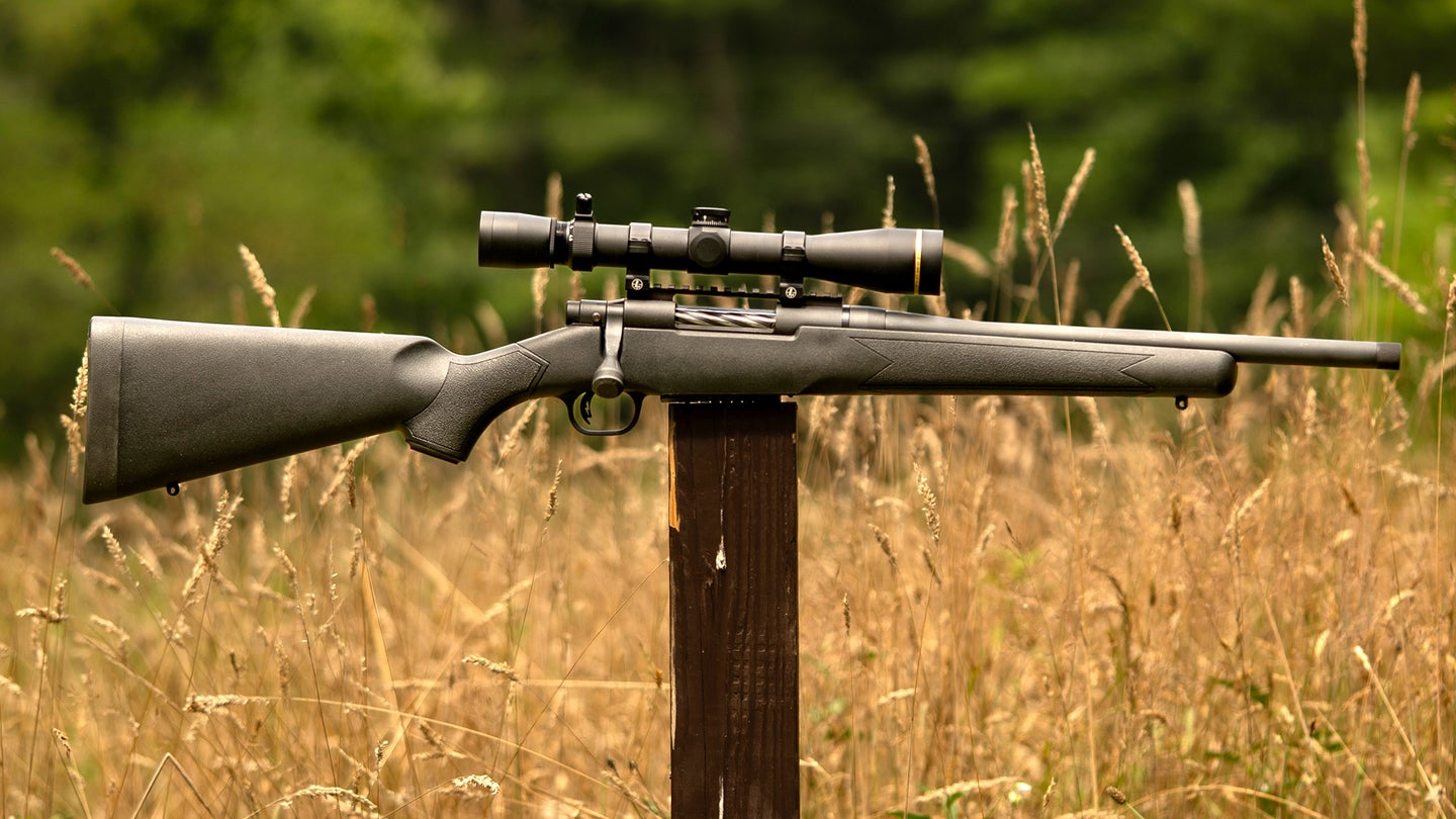Mossberg Patriot Predator SF rifle balanced on a post with a field in background