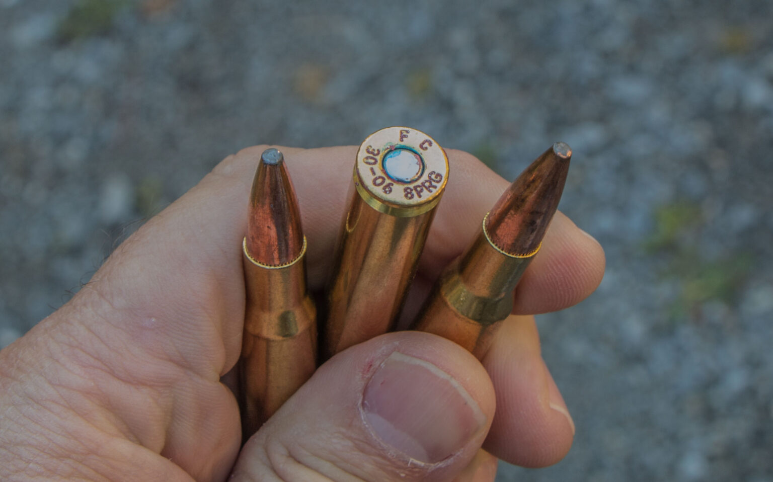 Hand holding rifle cartridges