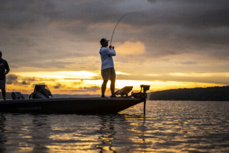 We Tested Dozens of Spinning Rods—These Are the Best for Bass Fishing Angler fishing on boat