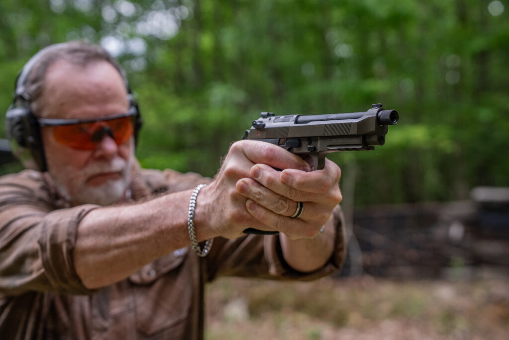 The Best Handguns of 2026, Tested and Reviewed A man tests a pistol to choose the best handguns