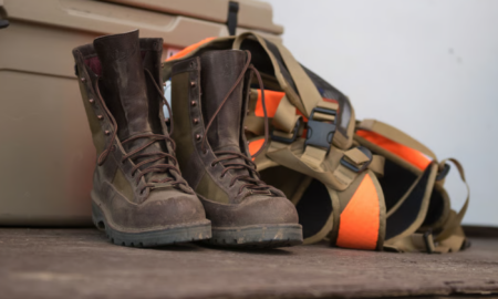 Danner hunting boots sitting next to upland vest