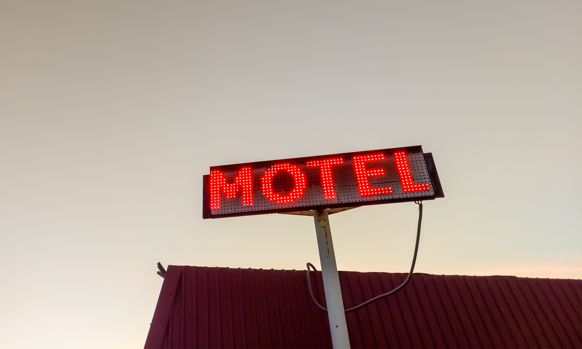 A motel sign against the sky