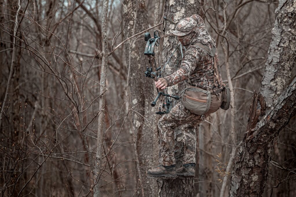 A bow hunter using a saddle take a shot