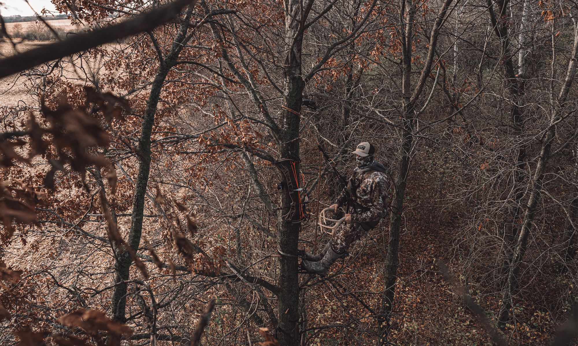 A bowhunter rattles in the timber. 