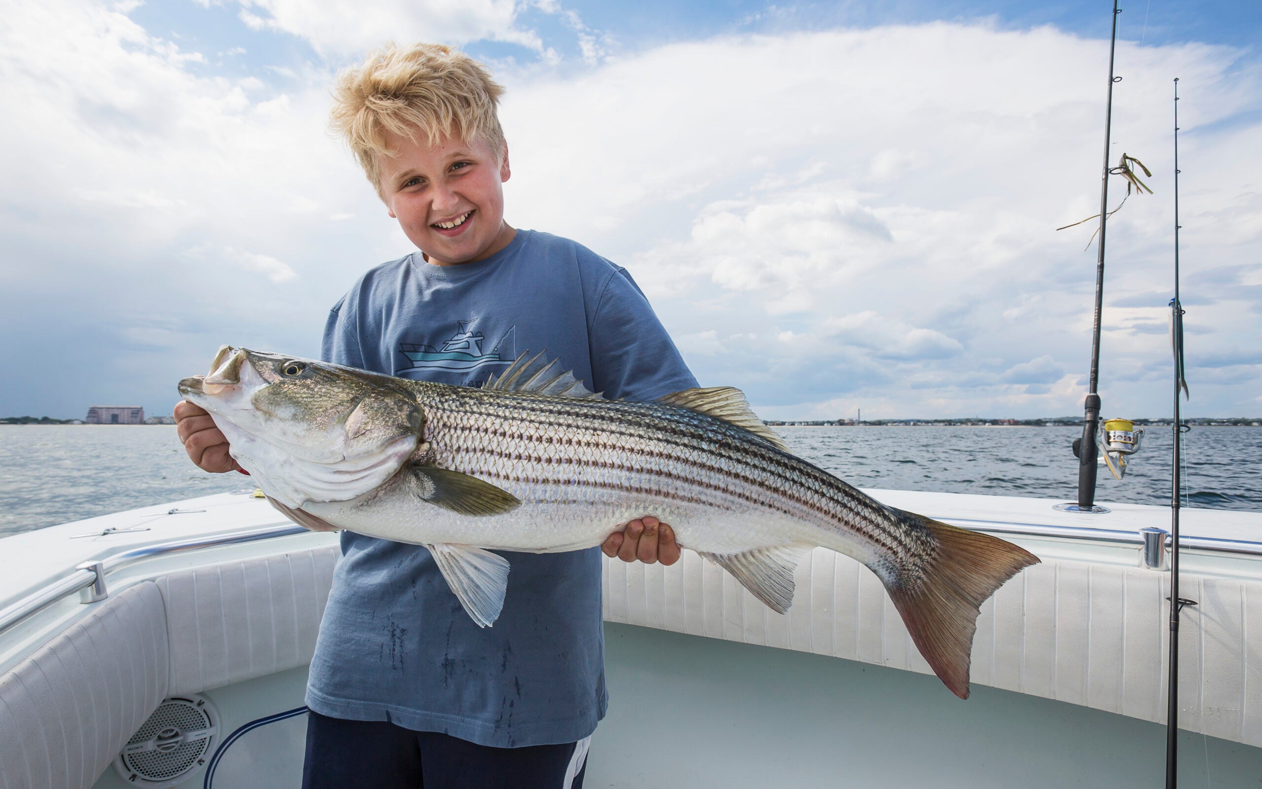 An angler holds a striped bass.