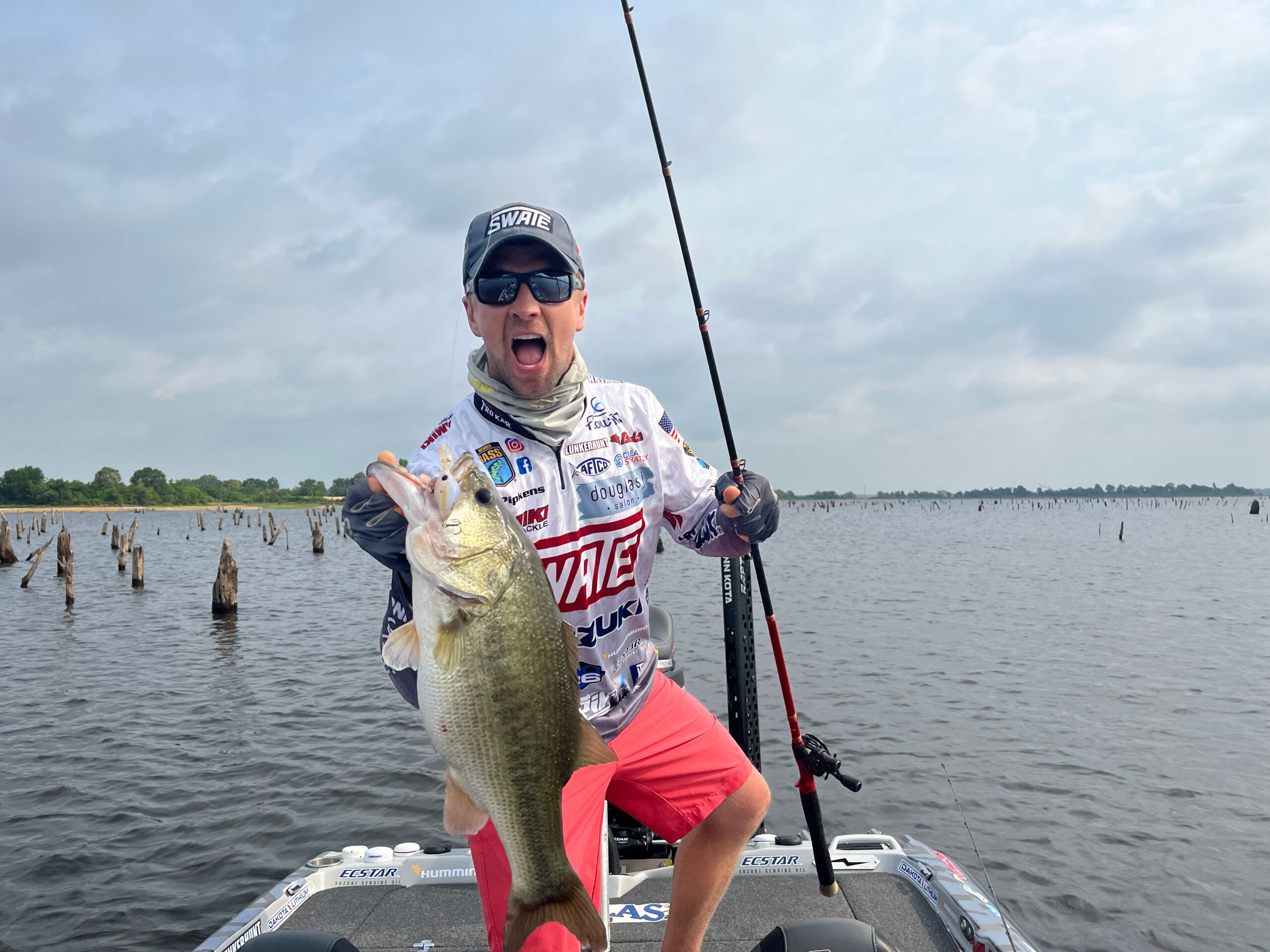 A professional bass fisherman poses with a trophy largemouth bass caught in Texas. 