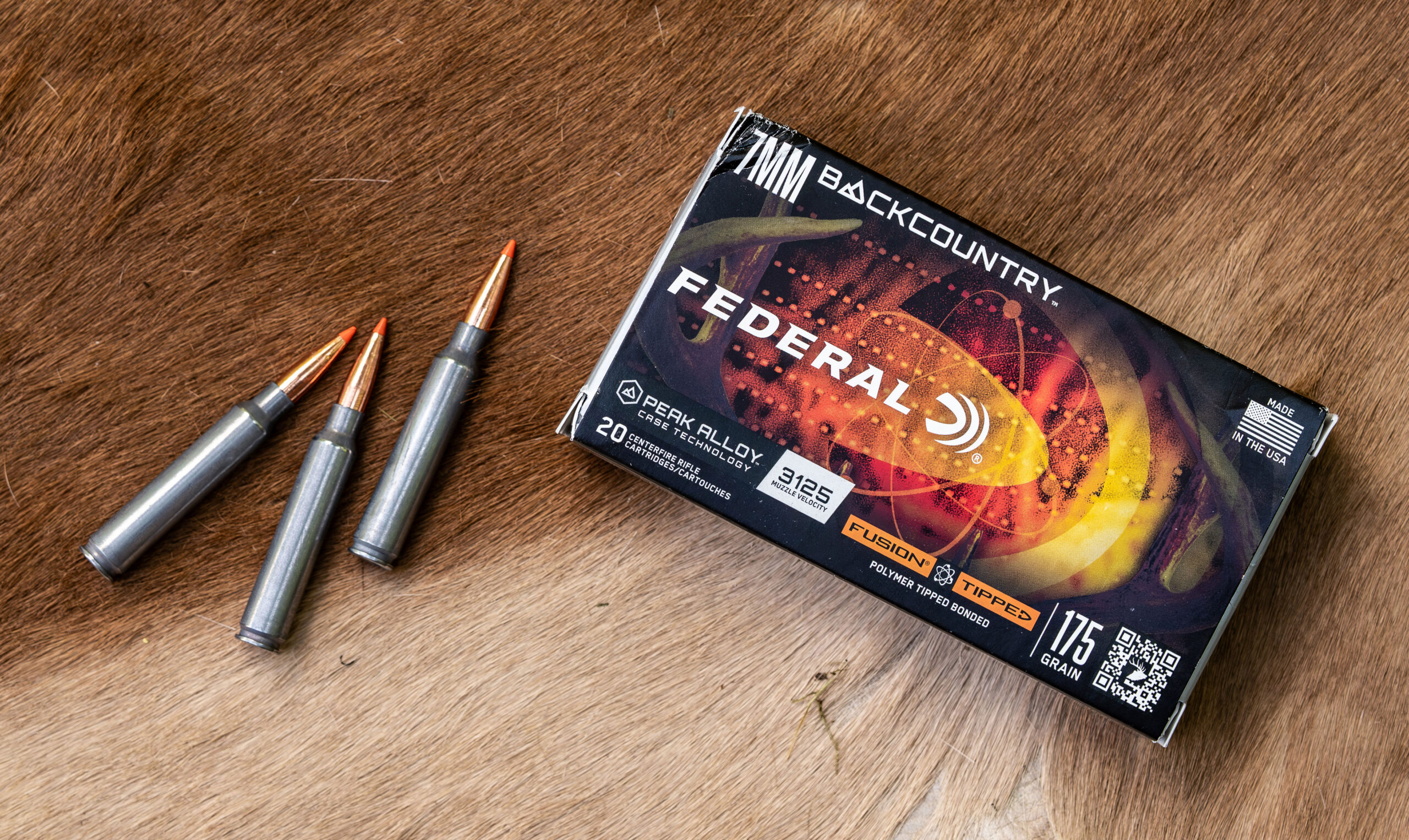 A box of 7mm Backcountry ammunition displayed on a deer hide. 