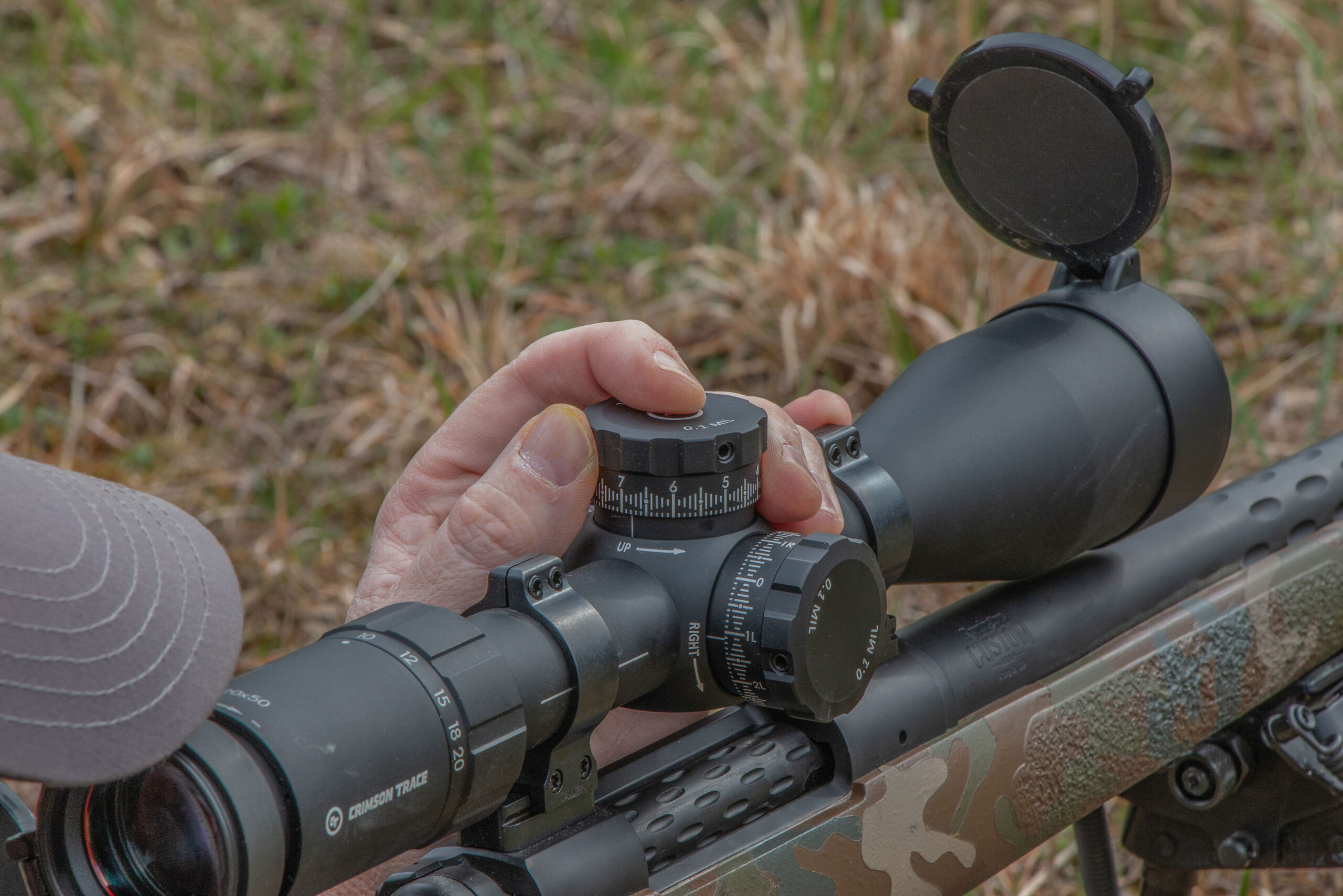 A shooter looks through a scope on a 7mm Backcountry. 