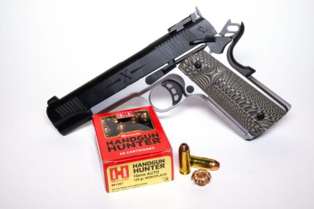 1911-style pistol with Hornady Handgun Hunter 10mm Auto ammunition box and loose rounds
