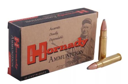 Hornady ammunition box with 20 cartridges and two rifle bullets displayed beside it