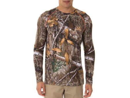 10 Things To Know Before You Buy Your First Set Of Camouflage For Deer Hunting Man wearing Realtree Edge camouflage long sleeve hunting shirt with orange accents