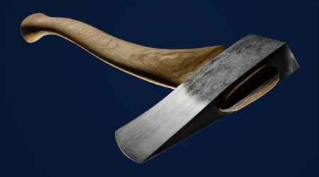 Great Old Gear: 14 Vintage Outdoor Tools That Have Stood the Test of Time Handcrafted wooden-handled steel axe with polished blade on dark blue background