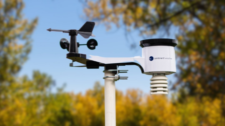 Ambient Weather personal weather station with anemometer and wind vane mounted outdoors