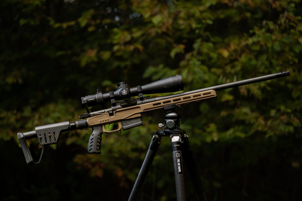 Bergara Premier MG Lite rifle on a tripod in a field.