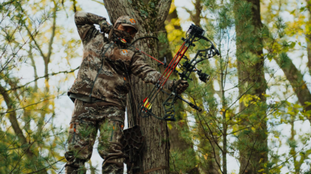 The Best Cyber Monday Hunting Deals, According to Our Experts Bowhunter in tree stand shooting Bear Archery compound bow
