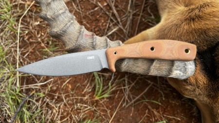 CRKT fixed blade hunting knife with brown Micarta handle resting on deer antlers