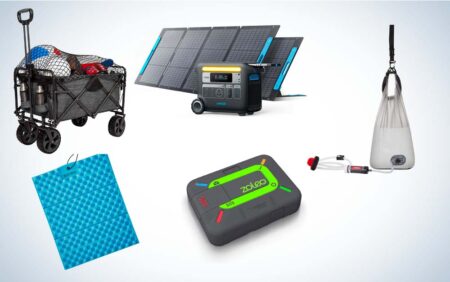 Camping gear including solar generator, folding wagon, sleeping pad, GPS device, and water filter