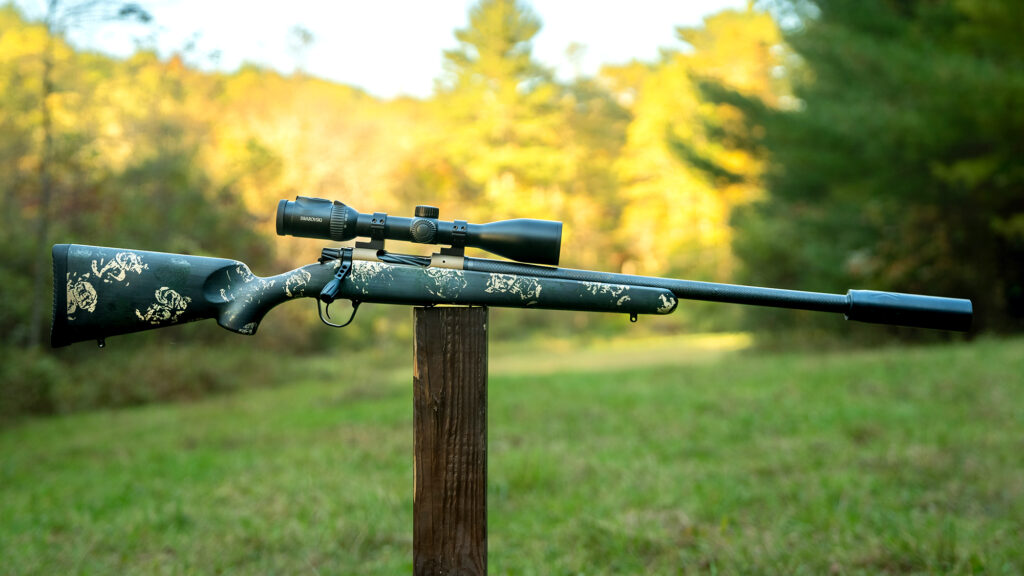 Christensen Ridgeline rifle balanced on a post in a field.