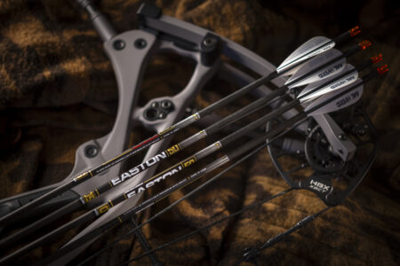 Easton carbon arrows with AE Hybrid vanes resting on a compound bow