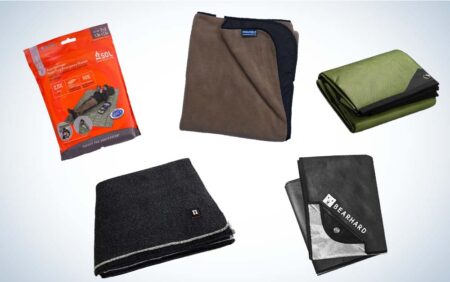 Five survival and camping blankets including SOL emergency blanket and Bearhard outdoor blanket.