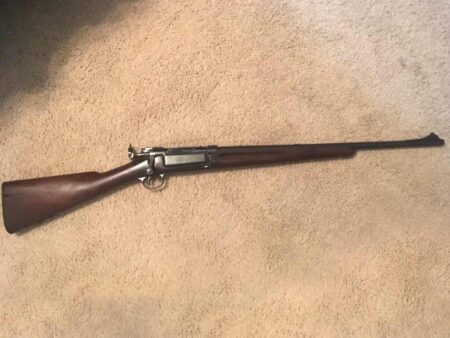 Blast from the Past: 1898 Springfield Krag Jorgensen Antique bolt-action military rifle with wooden stock lying on carpet