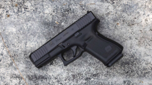 The Best Early Black Friday Glock Deals Right Now—Up to $125 Off Glock 23 Gen 4 compact .40 caliber pistol displayed on concrete surface
