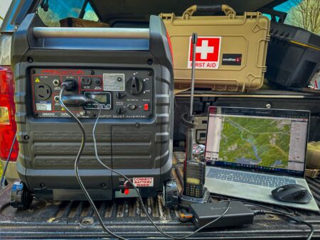 What Is An Inverter Generator? Predator 3500 inverter generator powering laptop and ham radio in truck bed with first aid kit