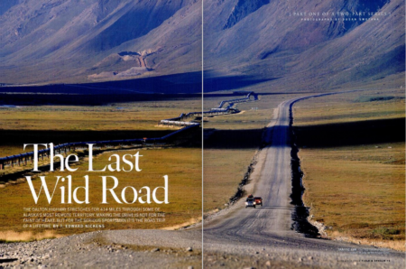 Dalton Highway stretching through remote Alaskan wilderness with Trans-Alaska Pipeline alongside