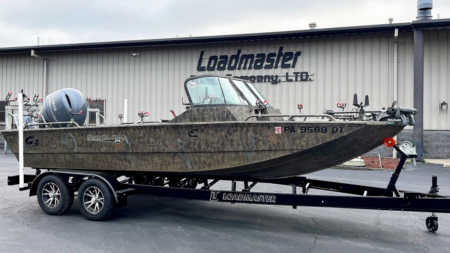 The Best Boat Trailer Tires (2024 Guide) G3 camo aluminum fishing boat on Loadmaster trailer outside dealership