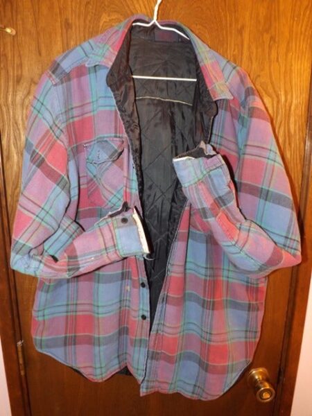 Quilted-lined plaid flannel shirt jacket in pink blue and green hung on door