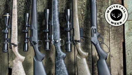 10 Modern Classic Deer Hunting Rifles Five hunting rifles with scopes displayed on wooden surface for Whitetail Week