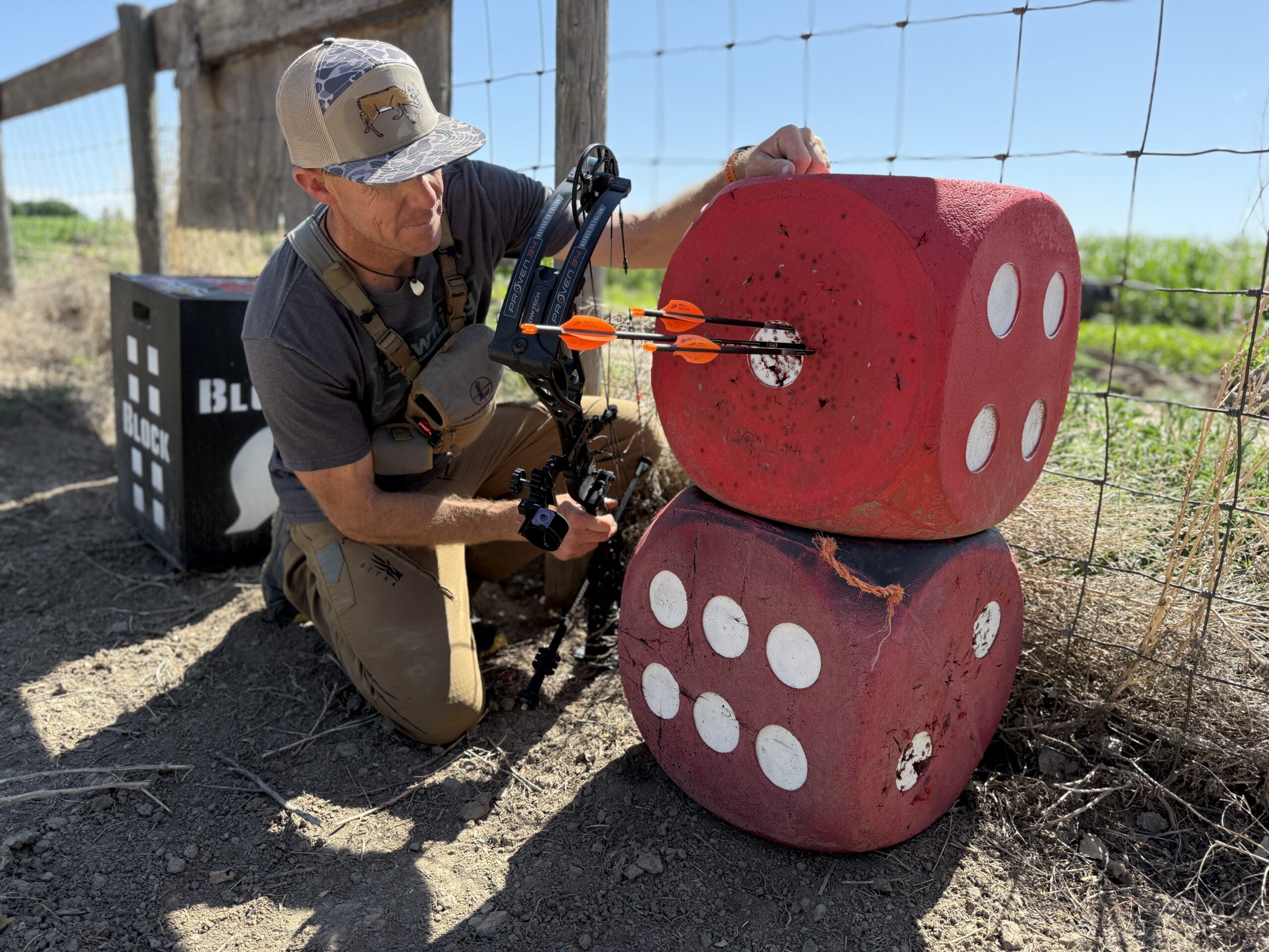 An archer pulls arrows from a Morrel High Roller foam archery target.