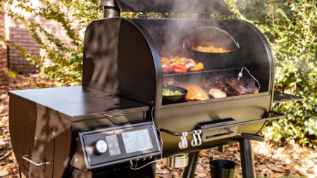 The 6 Best Smokers of 2024 Pellet smoker grill loaded with meats and vegetables producing smoke outdoors