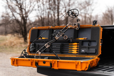 Prime Form Compound Bow Review: The Most Accurate Bow of 2025 Compound bow and orange arrows in open orange hard-shell protective case on truck bed