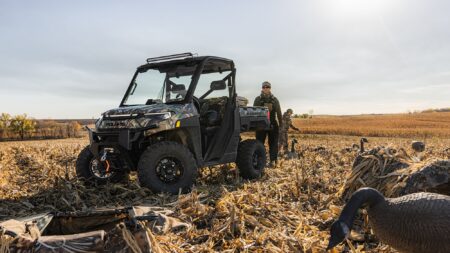 Hunters with Polaris Ranger UTV setting up duck decoys in harvested cornfield
