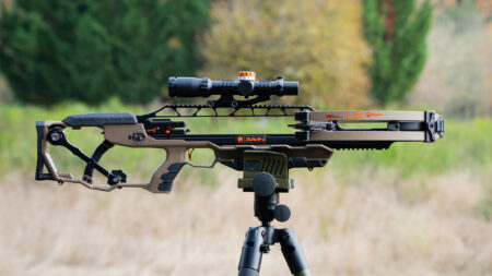 Ravin LR crossbow with scope mounted on tripod outdoors in nature