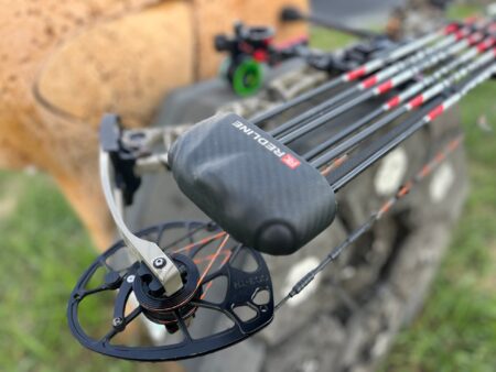 The Best Bow Quivers of 2024, Expert Tested Redline compound bow with carbon arrows and cam wheel closeup outdoors