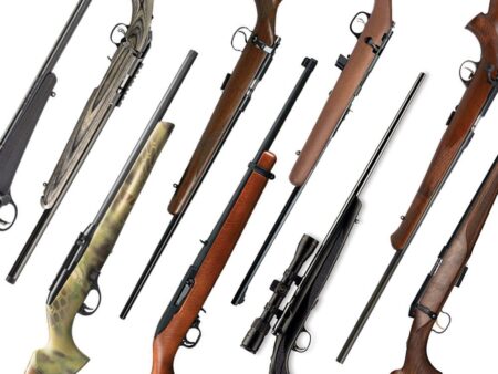 Collection of various hunting rifles and shotguns displayed on white background