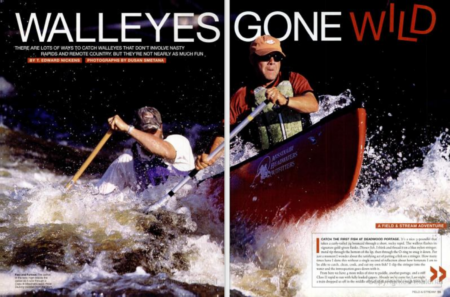 Two men paddling canoe through white water rapids for walleye fishing adventure
