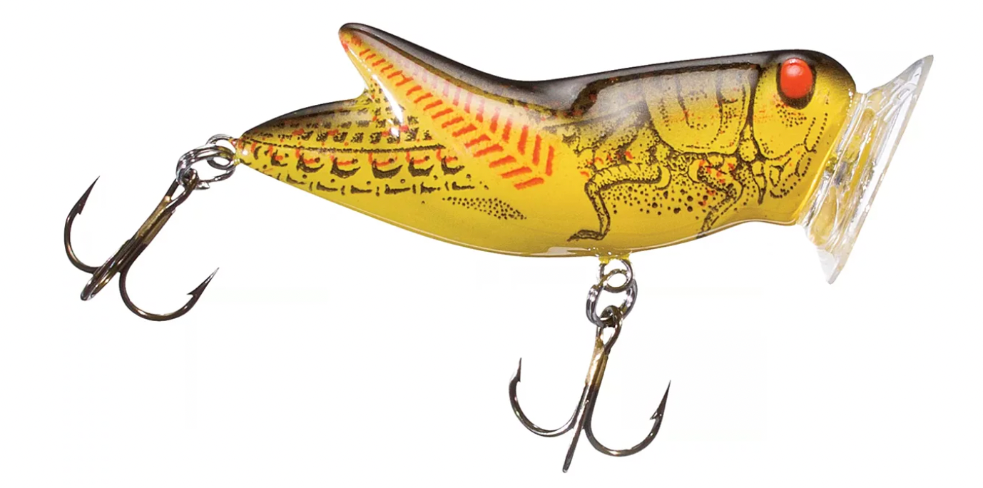 Yellow grasshopper fishing lure with treble hooks and red eye detail