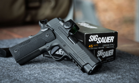 The Best Father’s Day Gun Sales Right Now (Up to 55% Off Glock, Sig Sauer, and More) Sig Sauer 1911 pistol with red dot sight resting on 45 Auto ammunition box